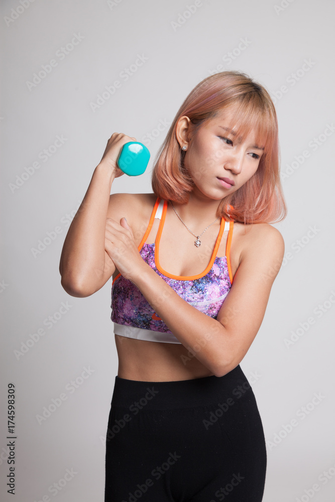 Asian healthy girl got arm pain with dumbbell. Asian healthy girl got arm pain with dumbbell.