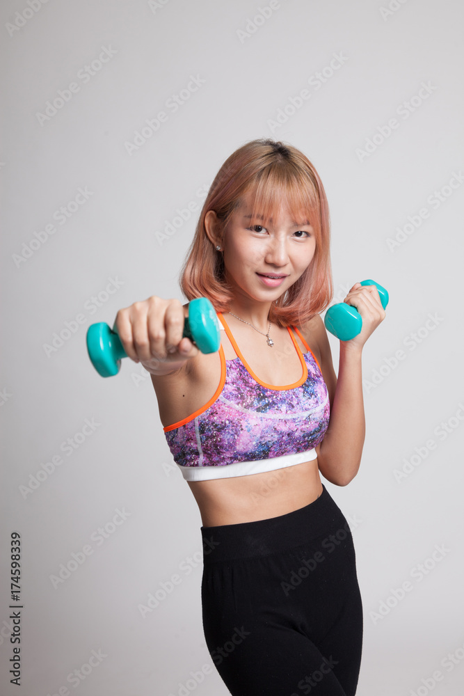Beautiful Asian healthy girl exercise with dumbbell. Beautiful Asian healthy girl exercise with dumbbell.