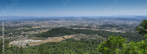 View from the mountain near the capital of the island Palma de Mallorca. Filds with mountains covered with haze