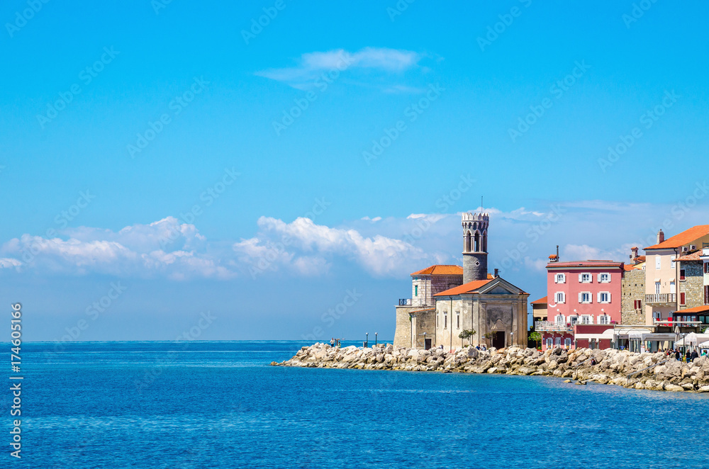 Rocky promontory, lighthouse and tower church of Clement, Piran, Slovenia Europe