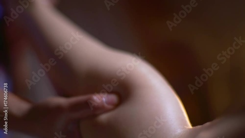 massage of the female back. hands of the masseuse, foot massage photo