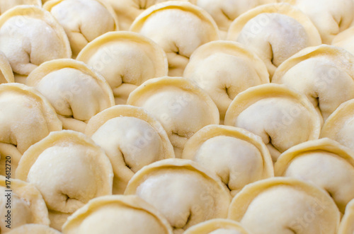 Fresh homemade raw dumplings background texture