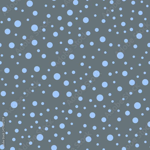 Blue polka dots seamless pattern on grey background. Magnificent classic blue polka dots textile pattern in restrained colours. Seamless scattered confetti fall chaotic decor. Vector illustration.