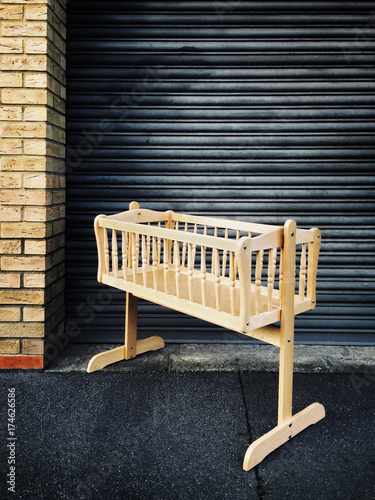 A baby`s cot left in the street photo