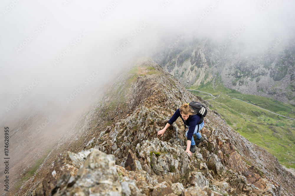 Female climber in rugged mountains. Female climber in rugged mountains.