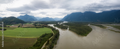 Aerial view of the Farm lands, fraser river and the beautiful mountain landscape. Taken in Agassiz, British Columbia, Canada. photo