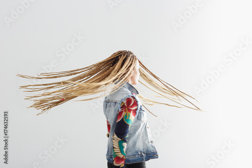 Young African-American woman with braider hair on white background photo