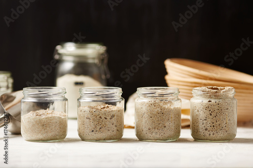 Four glass jars with sourdough photo