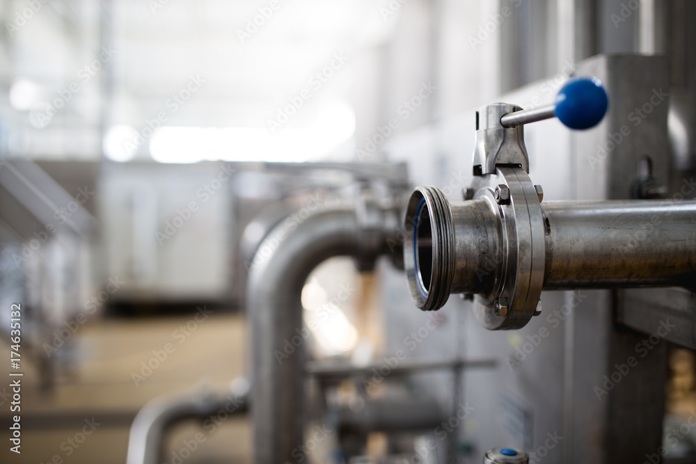 Close up details from factory for purification and bottling of drinking water into bottles and canisters. Pipes and valves.