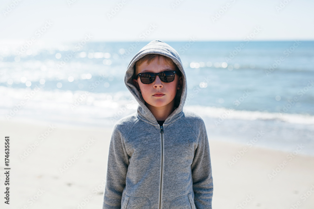 portrait of a boy on the beach on a chilly day portrait of a boy on the beach on a chilly day