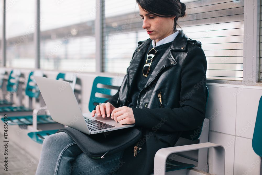 Stylish woman waiting for the train