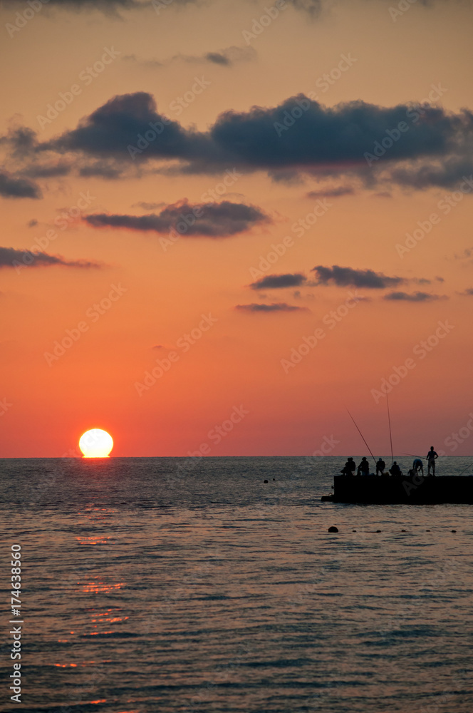 Sunset. Silhouettes of fishermen. Sunset. Silhouettes of fishermen.