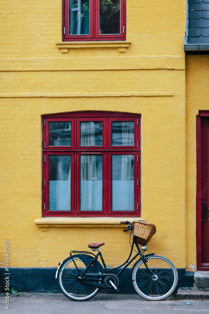 Bike parked near the yellow house Bike parked near the yellow house