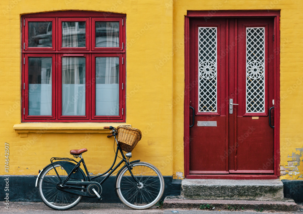 Bike parked near the yellow house Bike parked near the yellow house