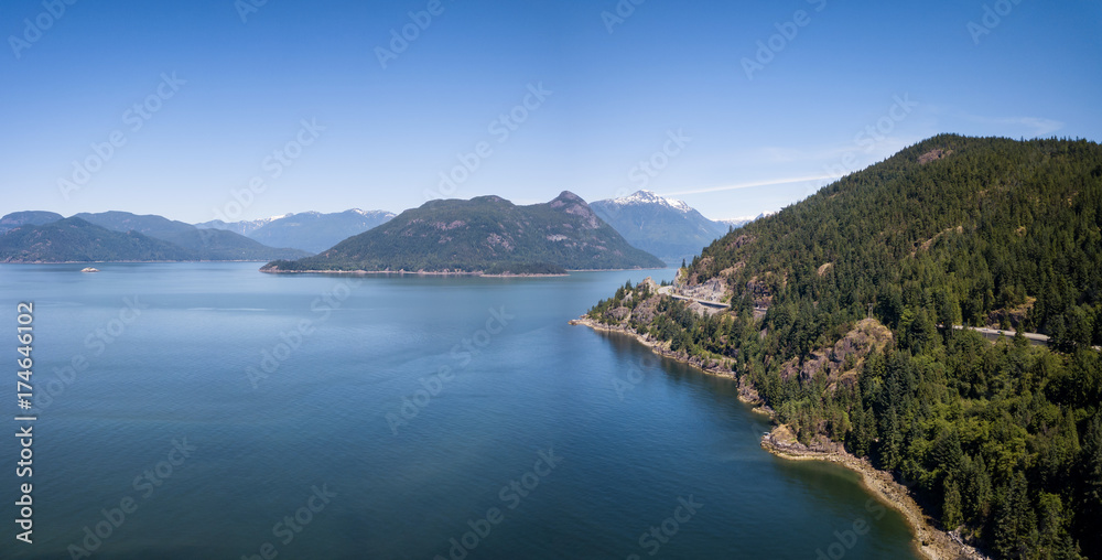 Aerial Panoramic Landscape view of Howe Sound and Sea to Sky Highway. Taken North of Vancouver, British Columbia, Canada, during a sunny summer day.