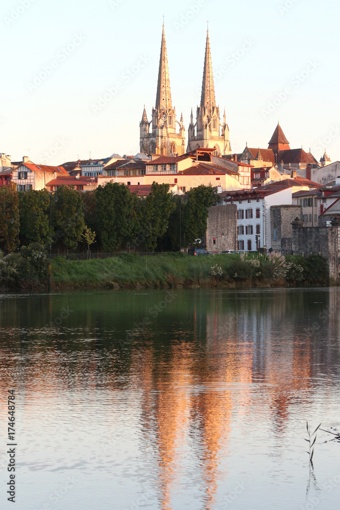 cathedrale de bayonne and its reflection in the water at sunrise