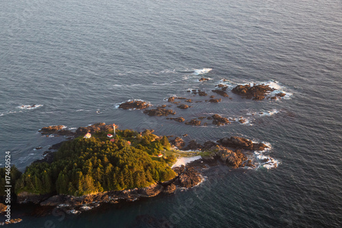 Lighthouse on Lennard Island near Tofino, Vancouver Island, British Columbia, Canada. Taken from an aerial perspective on a summer sunset. photo