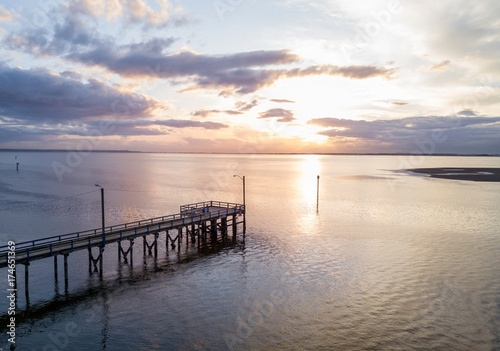 Aerial view on the wooden quay on Pacific Ocean. Picture taken in White Rock  Greater Vancouver  BC  Canada  during a cloudy sunset.