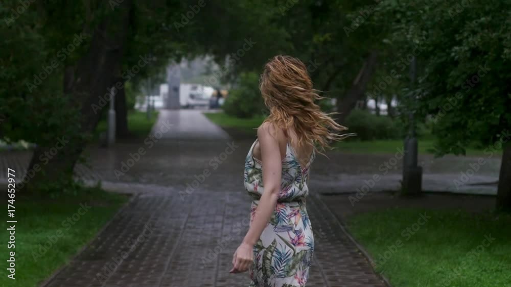 portrait of young beautiful woman in rain. slow motion portrait of young beautiful woman in rain. slow motion