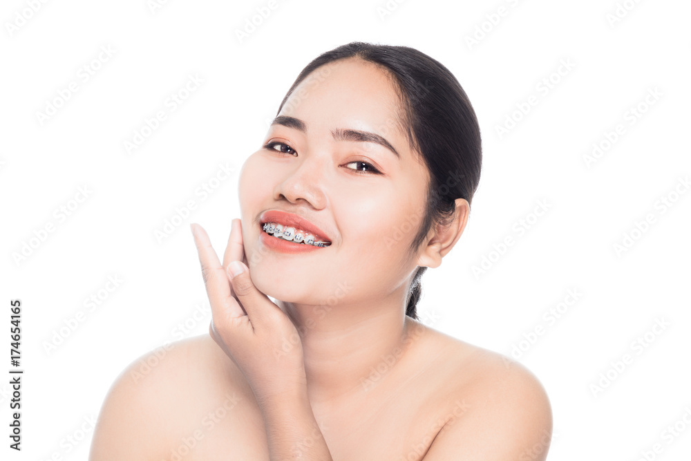 Beautiful woman face with teeth brace dental close up portrait studio on white background