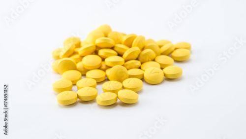 yellow tablets stack on white background
