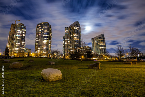 Night scene in George Wainborn Park with residential buildings in the background. Picture taken during a cloudy night with a full moon. photo