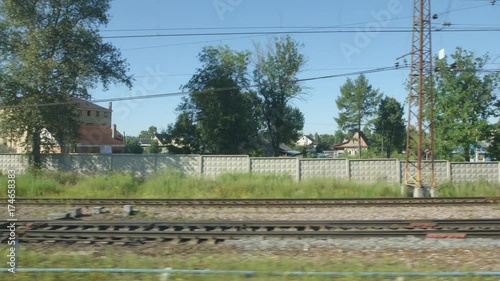 POV: High-speed Train moves past a railway station in a small town photo