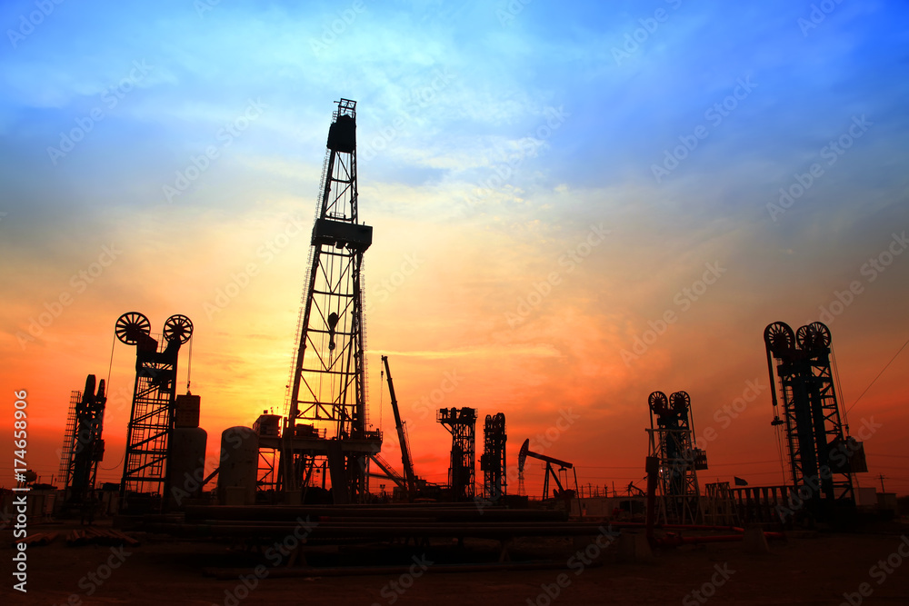 the silhouette of oilfield derrick