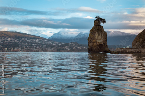 Early morning view of Siwash Rock in Stanley Park, with North Vancouver, BC, Canada, in the background.