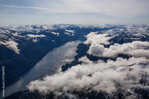Aerial landscape view of the lake surrounded by the mountains. Taken far remote North West from Vancouver, British Columbia, Canada.