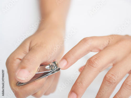 Closeup of a woman cutting nails  health care concept.