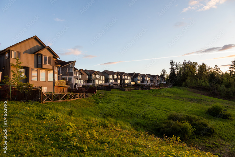 Luxury homes on top of a hill during a beautiful sunset.