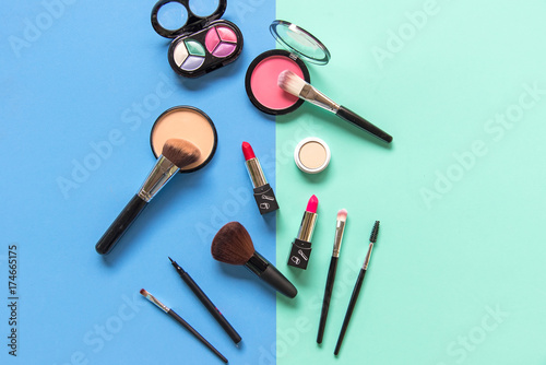 Set cosmetics makeup, brush, eye shadow and lipstick, colourful blue and green background. Lifestyle Concept.