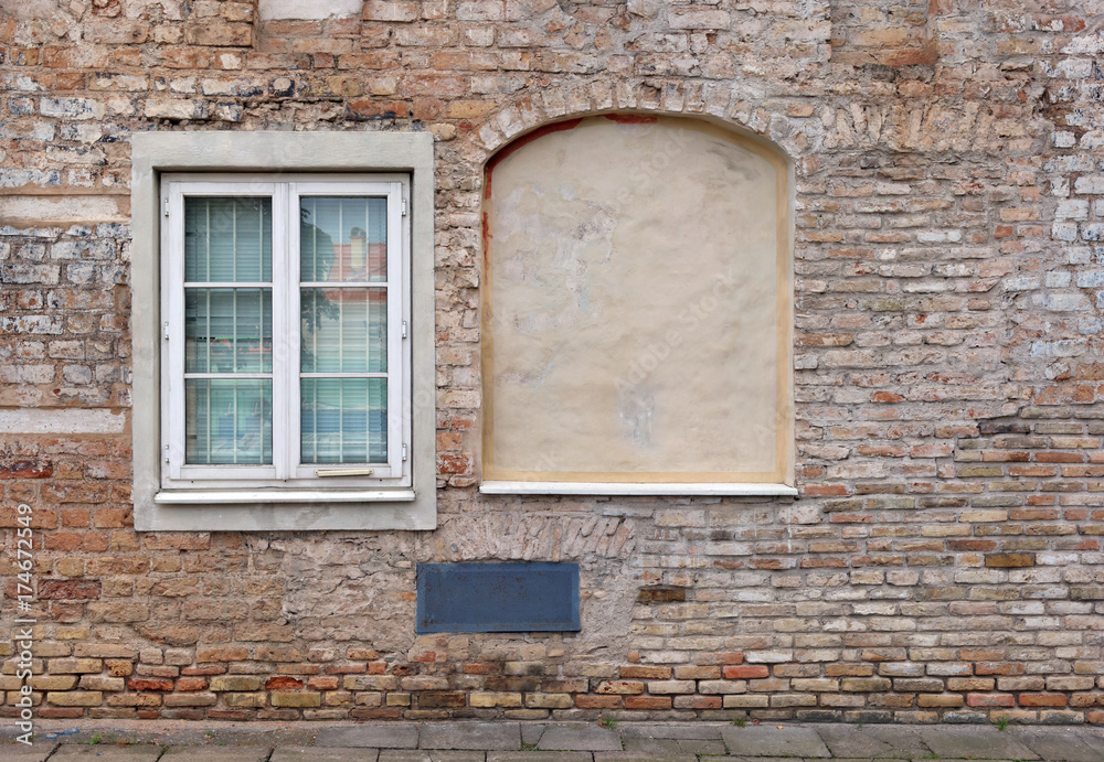 Blind curved basement windows in the old aged red bricks house. Blind curved basement windows in the old aged red bricks house.