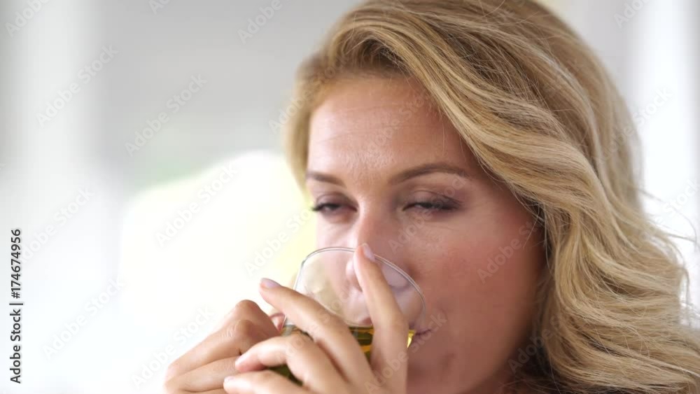 Portrait of attractive woman in bathrobe drinking infusion Portrait of attractive woman in bathrobe drinking infusion