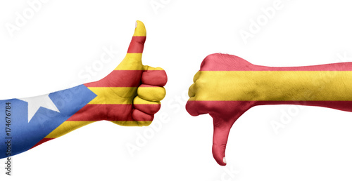 Spanish and Catalan flag painted on the hands with the thumbs up and down. Referendum photo