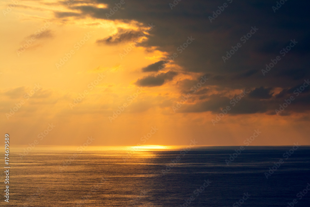 Sunset over the sea. Seashore with beautiful picturesque sky