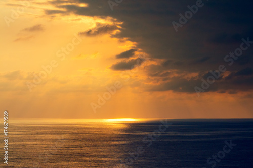 Sunset over the sea. Seashore with beautiful picturesque sky