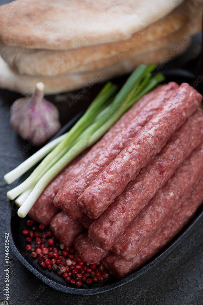 Closeup of fresh uncooked cevapcici or skinless beef sausages, selective focus Closeup of fresh uncooked cevapcici or skinless beef sausages, selective focus