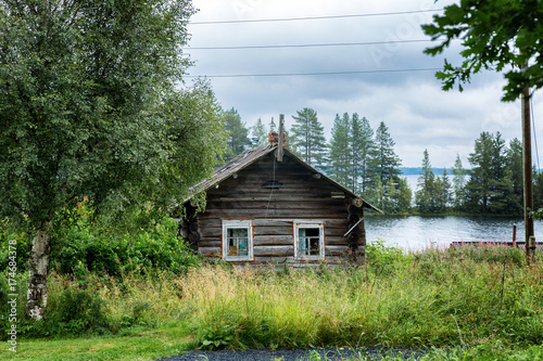old wooden house on the lake in the forest