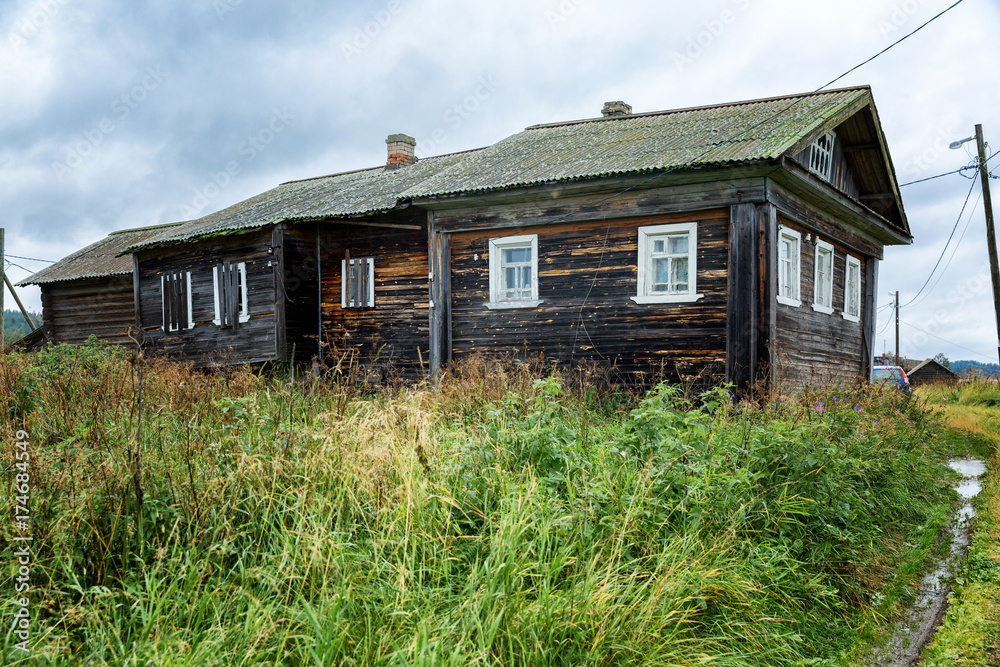 old wooden house, in the courtyard of the board, green grass