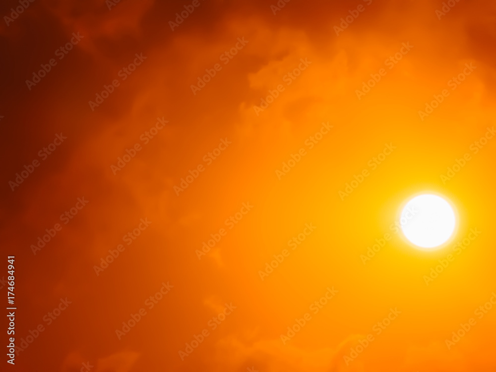 Sun up high in the sky with clouds in red and orange atmosphere