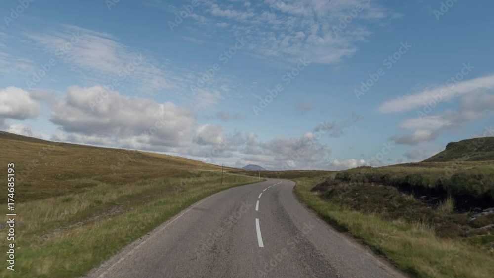 POV shot from a camera attached to the front of a vehicle driving through beautiful empty roads in the scottish highlands POV shot from a camera attached to the front of a vehicle driving through beautiful empty roads in the scottish highlands