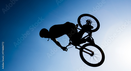 bmx rider performing stunts in the air