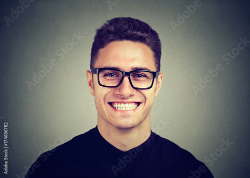 Portrait of a happy young man in glasses
