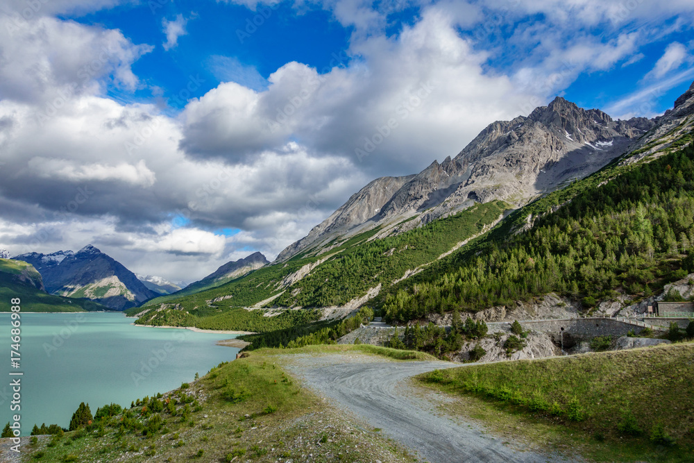 Obraz premium Lake of Cancano, track and mountains Bormio (Province of Sondrio)