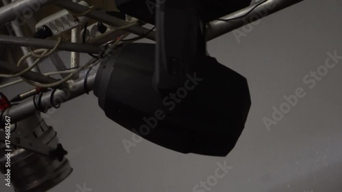 strobe lights emitting different color beams hanging under the ceiling.