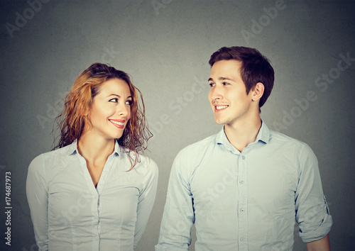 Fotografie Beautiful couple is looking at each other and smiling