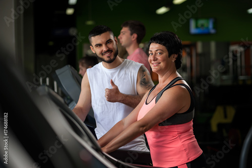 Happy smiling brunette woman and fitness coach