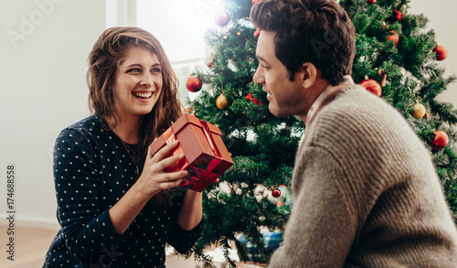 Young couple celebrating Christmas at home.